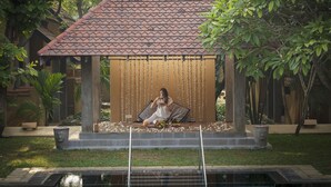 A gazebo with a tiled roof, surrounded by greenery and a small pool. - Jetwing Ayurveda Pavilions (Negombo)