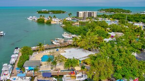 A coastal area with a marina, boats, and a small island with buildings. - Captain Pips Marina & Hideaway (Marathon)