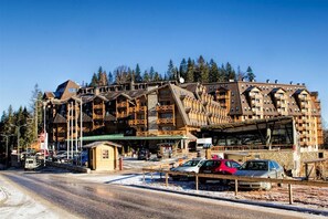 A large, multi-story wooden building with a ski lift and a small cabin. - Aparthotel Vučko (East Sarajevo)