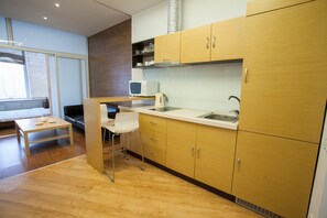 Apartment, 2 Bedrooms, Kitchen | Living area | 100-cm flat-screen TV with satellite channels, LED TV, DVD player