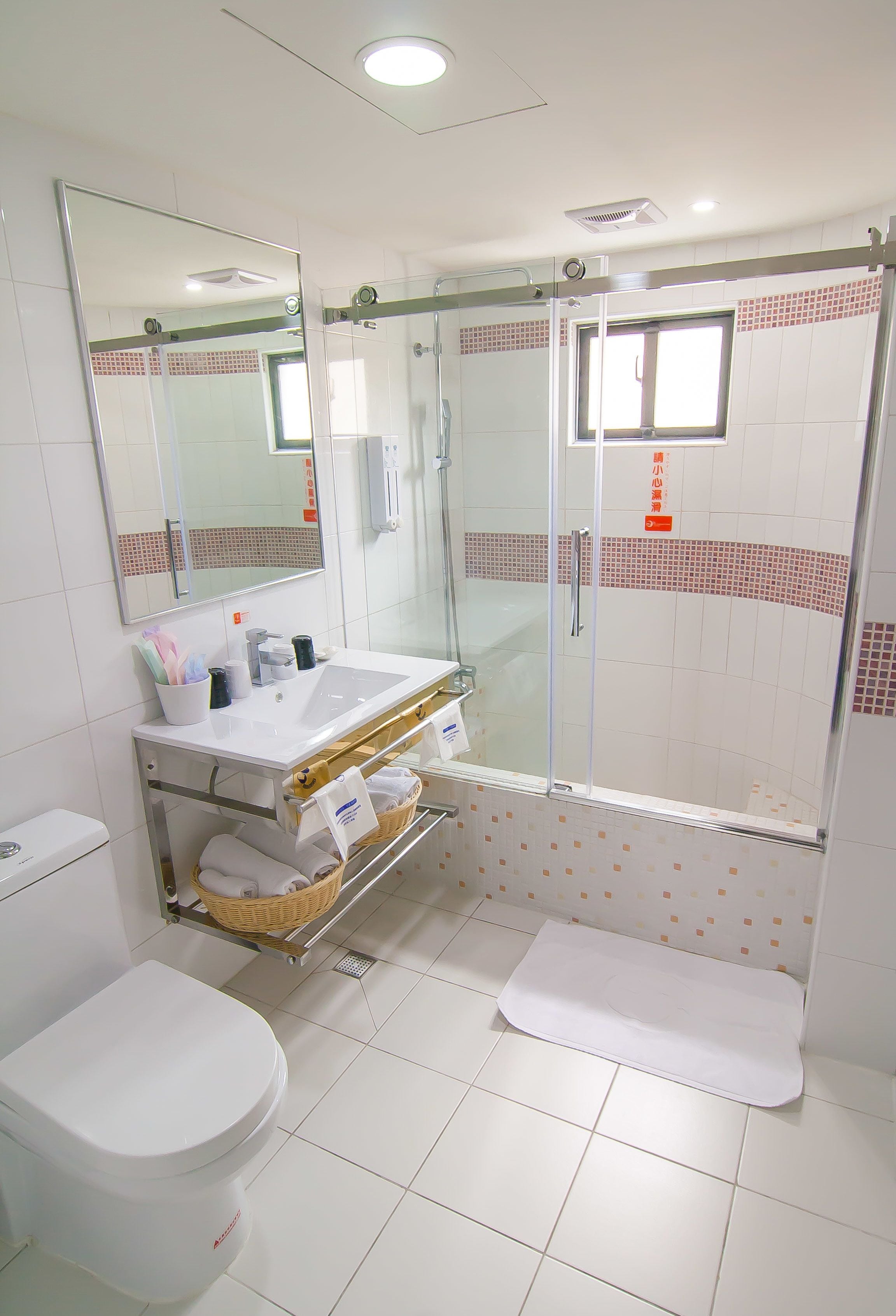deluxe quadruple room, 2 queen beds | bathroom | rainfall showerhead, hair dryer, bidet, towels