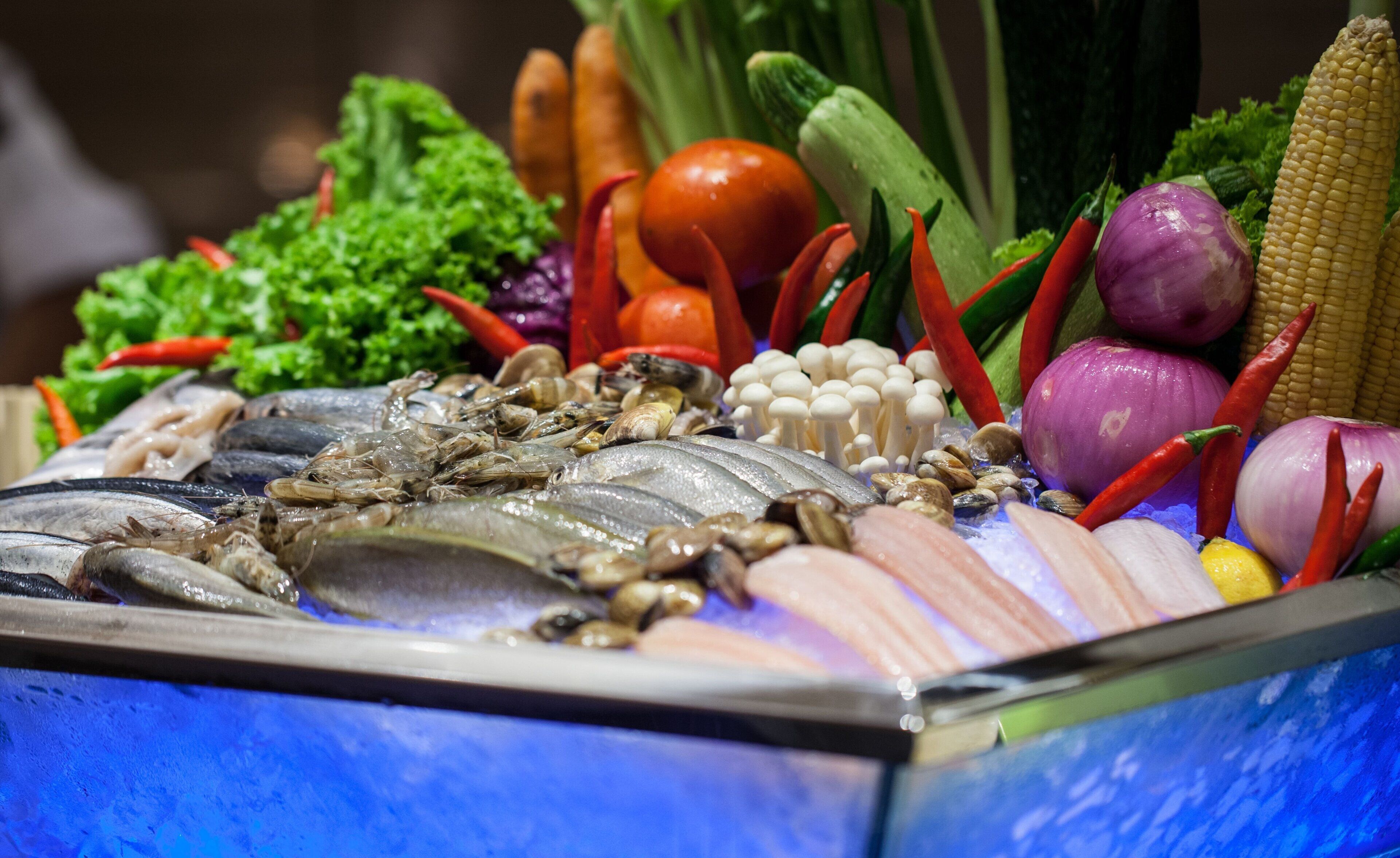 A variety of seafood including fish, shrimp, and clams.