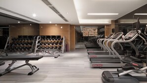 A gym with treadmills, dumbbells, and a bench. - Holiday Inn Chengdu Oriental Plaza by IHG (Chengdu)