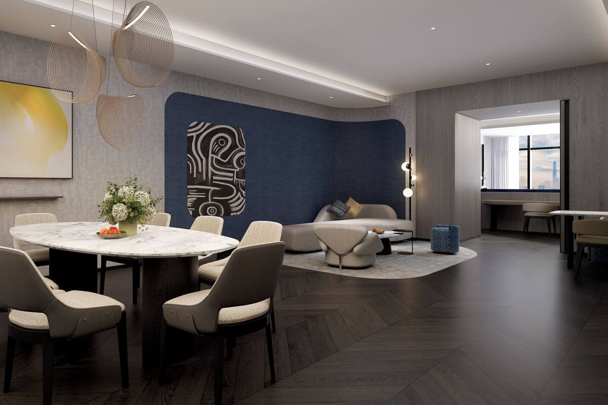 Ein modernes Interieur mit einem runden Esstisch, Stühlen, einer Couch und einem großen abstrakten Gemälde an der Wand.