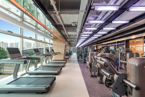 A gym with treadmills, exercise bikes, and weight machines. - voco Suites Shenzhen Huanggang by IHG (Shenzhen)