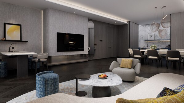 A modern living room with a flat-screen TV, seating area, and a dining space.