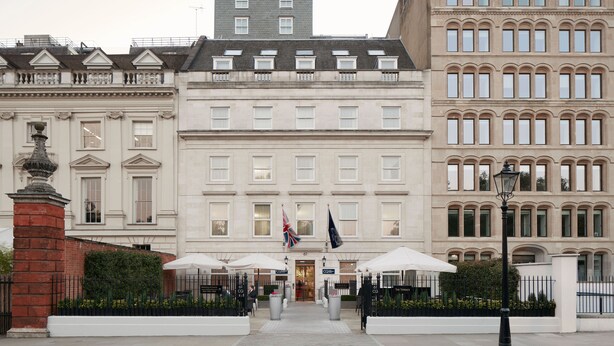 A grand building with a symmetrical facade, large windows, and a central entrance.