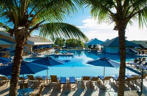 A pool area with multiple pools, sun loungers, and umbrellas. - Infinity Blue Resort & Spa (Balneário Camboriú)