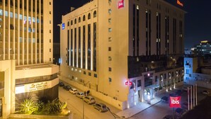 A multi-story building with a prominent "ibis" sign on the top right. - ibis Tunis (Tunis)