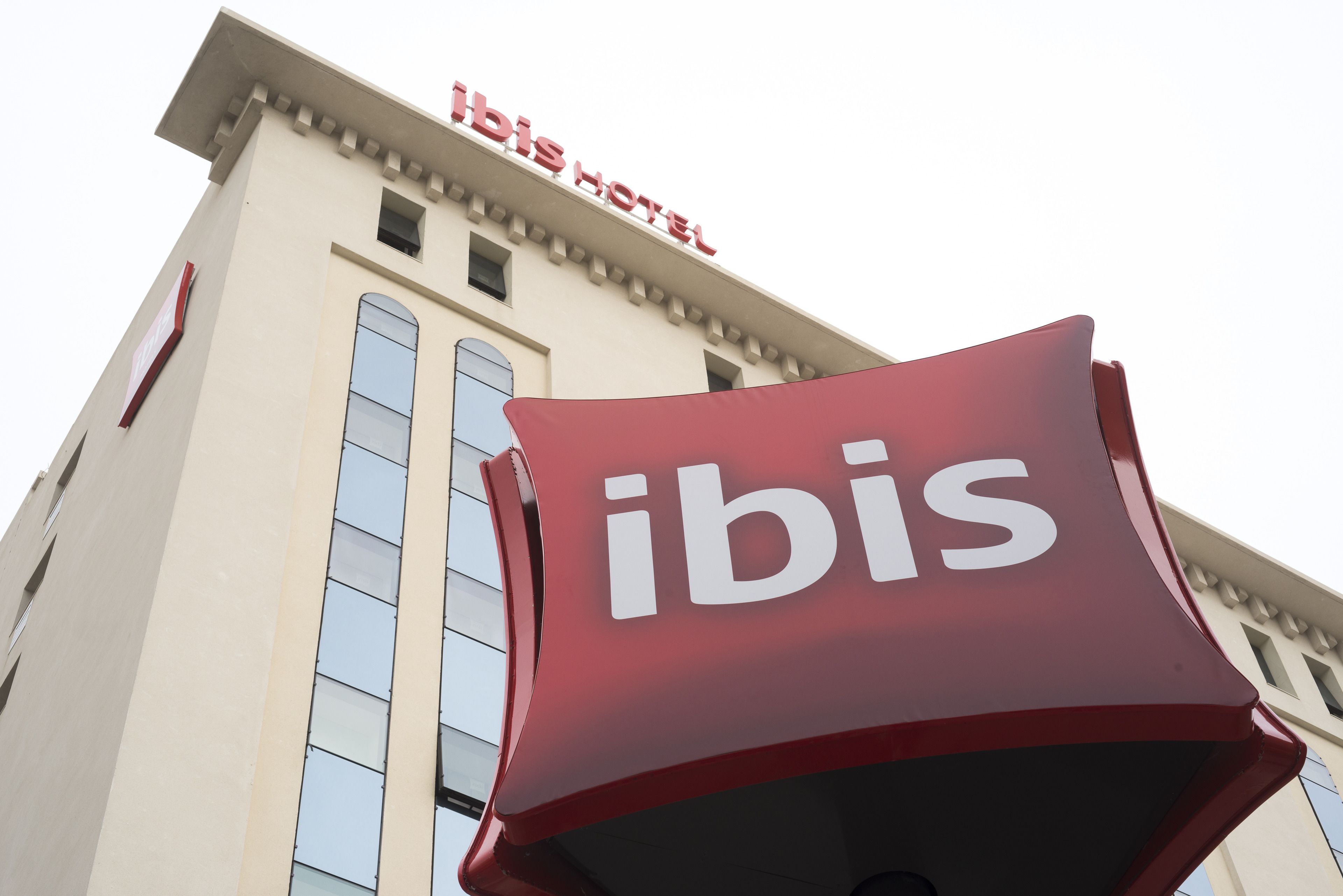 A hotel with a prominent 'ibis' sign and a classic architectural style.