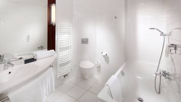 A modern bathroom with a bathtub, a toilet, and a sink.