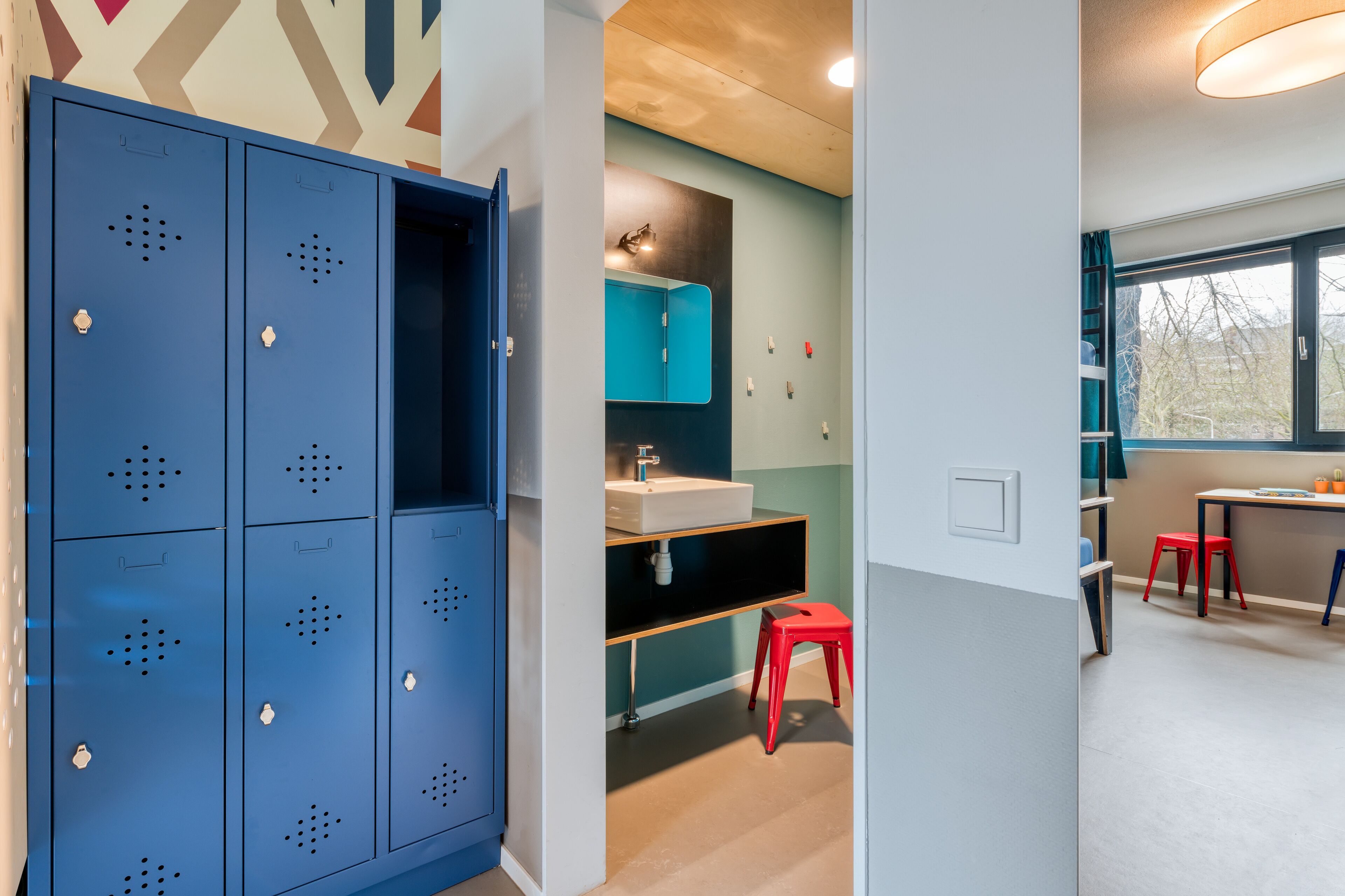 A modern bathroom with a sink, mirror, and blue cabinets.