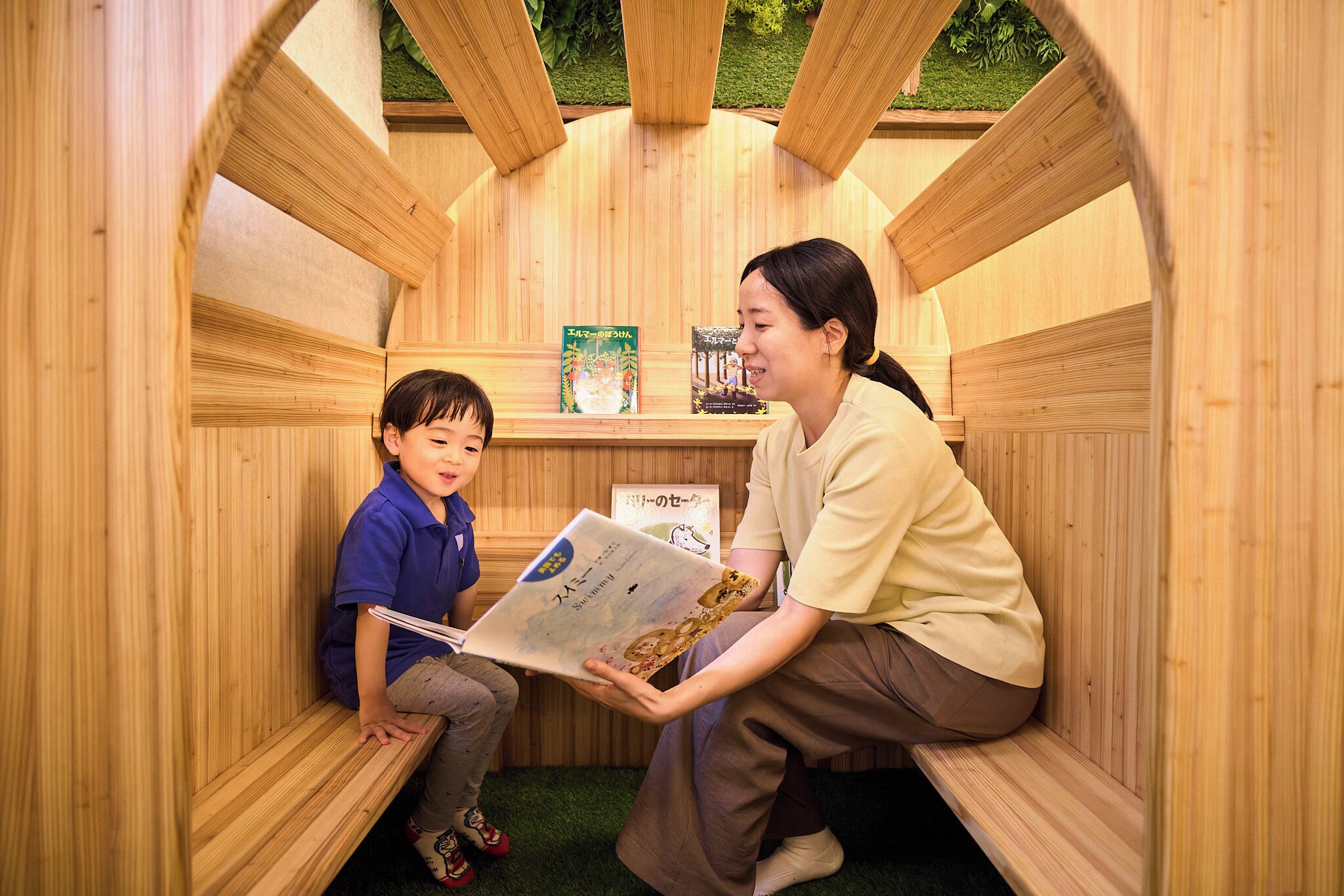 A wooden structure with two people reading books.
