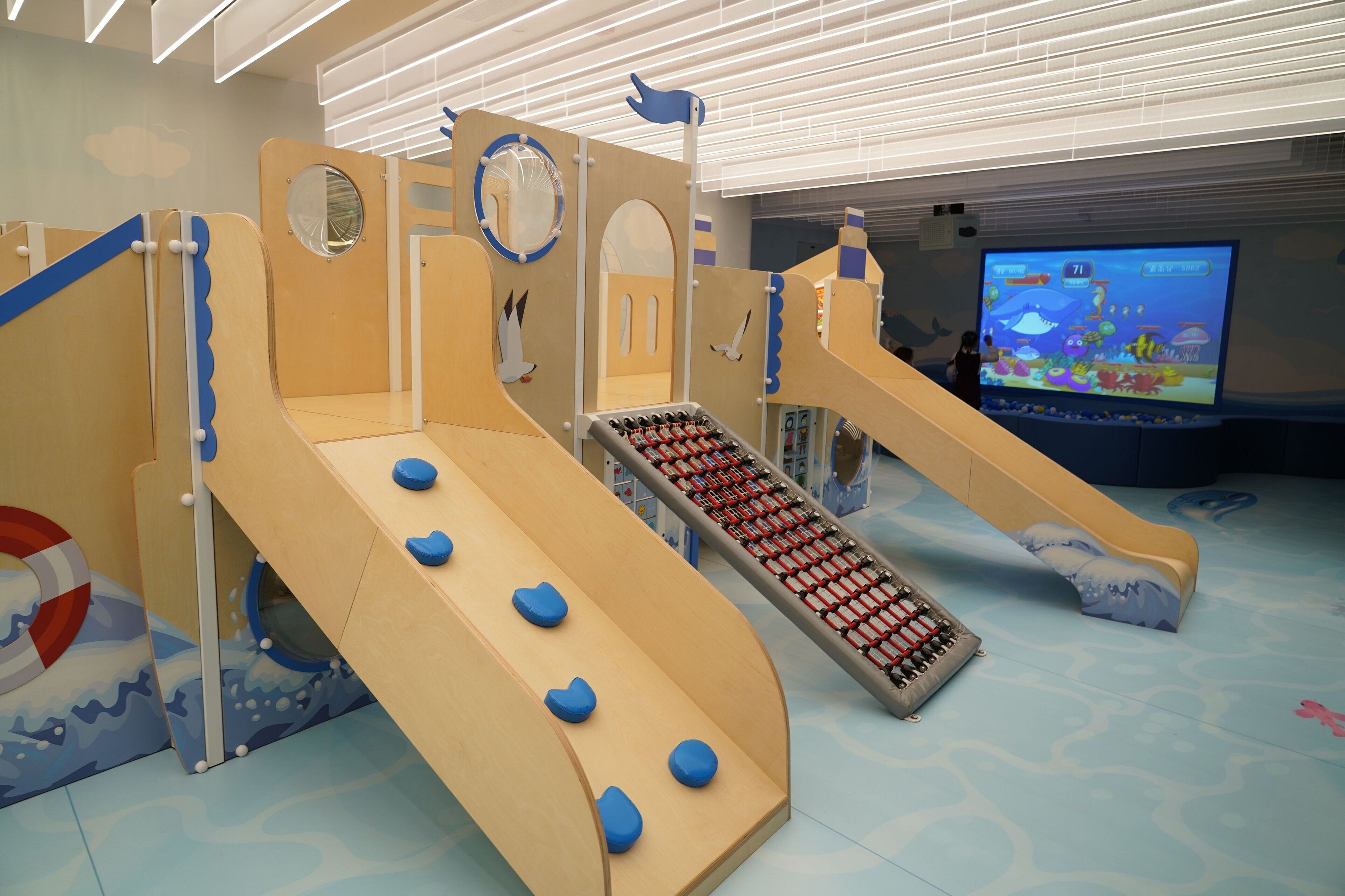 A children's play area with slides and climbing structures.