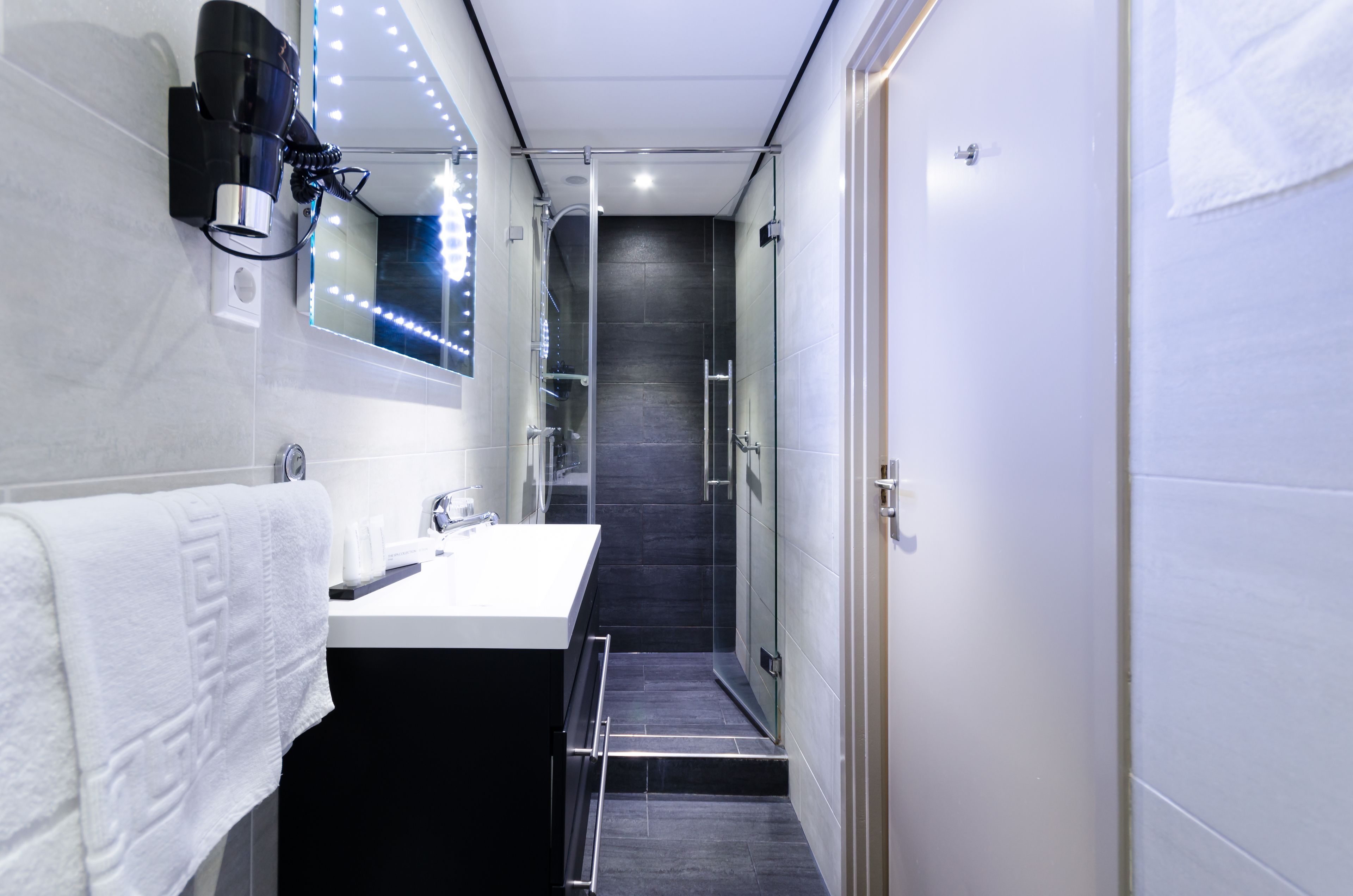 designer toiletries, hair dryer, towels