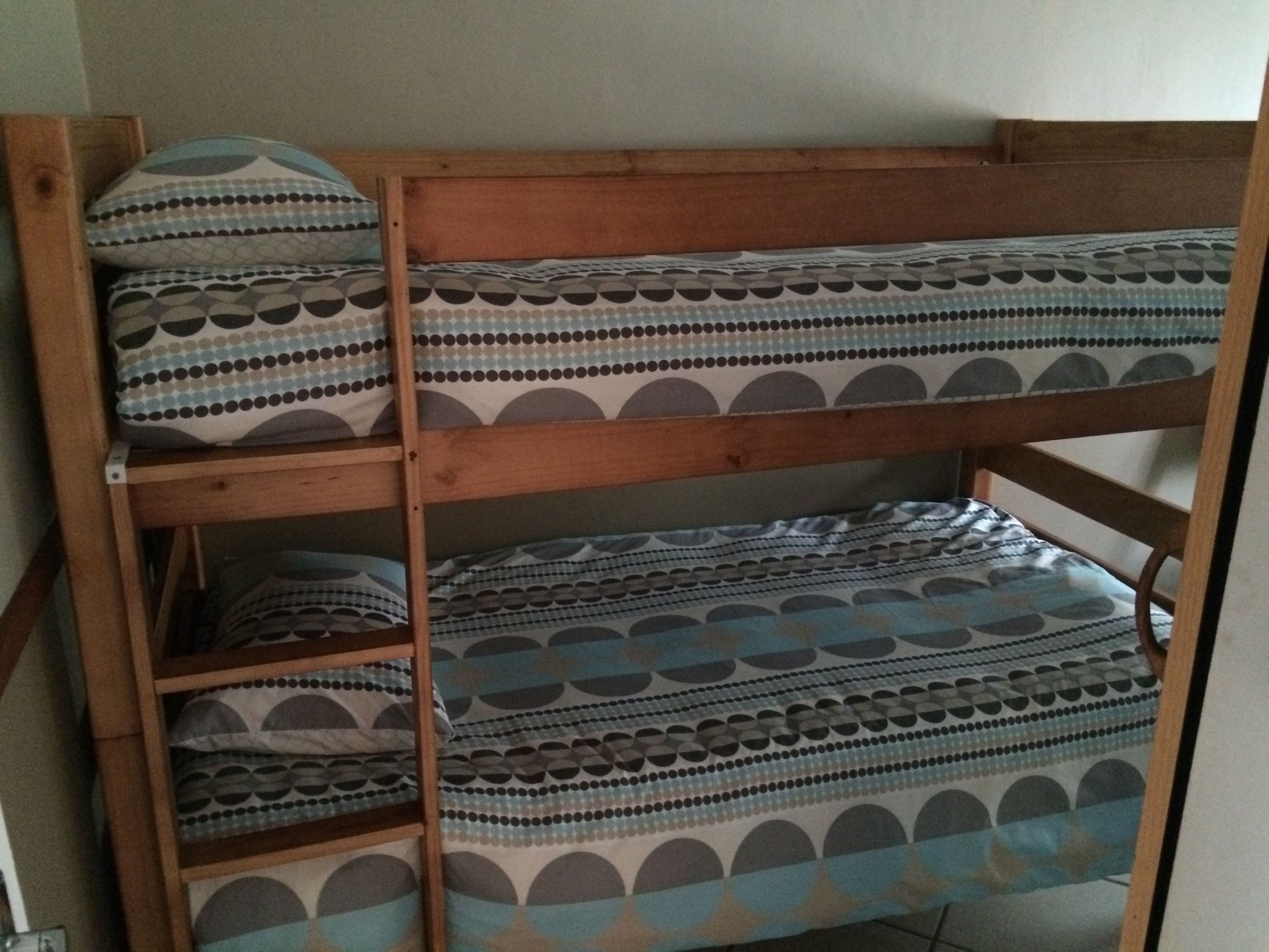 A bunk bed with patterned bedding.