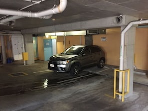 A parking garage with a car parked in a spot. - Silkari The Pavilions Port Douglas (Port Douglas)