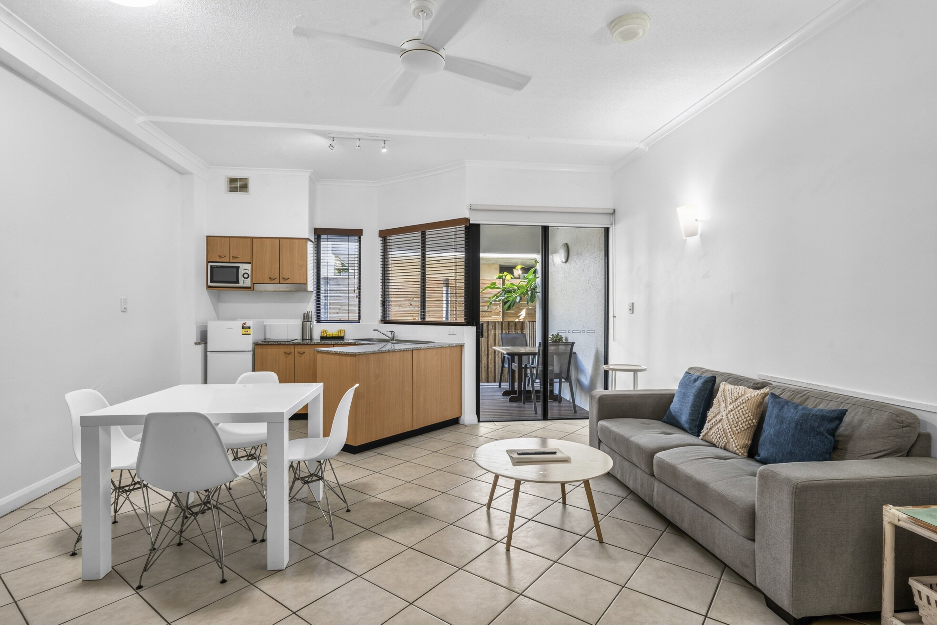 A modern apartment with a dining area, kitchen, and living room.