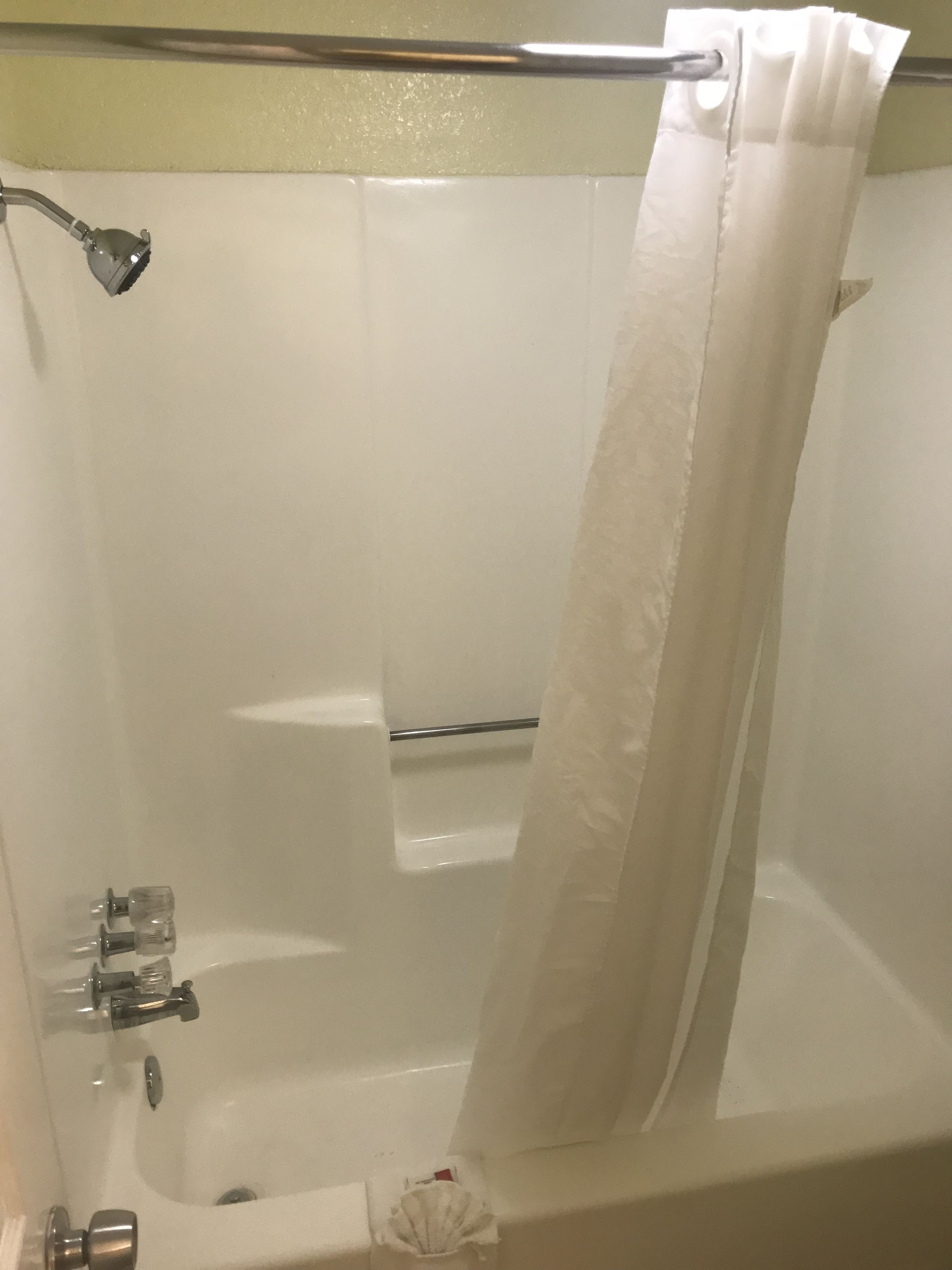 A bathroom with a bathtub, a shower, and a toilet.