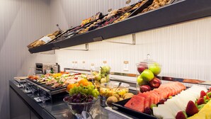 A buffet with various fruits, vegetables, and pastries. - Ikonik Ramblas (Barcelona)