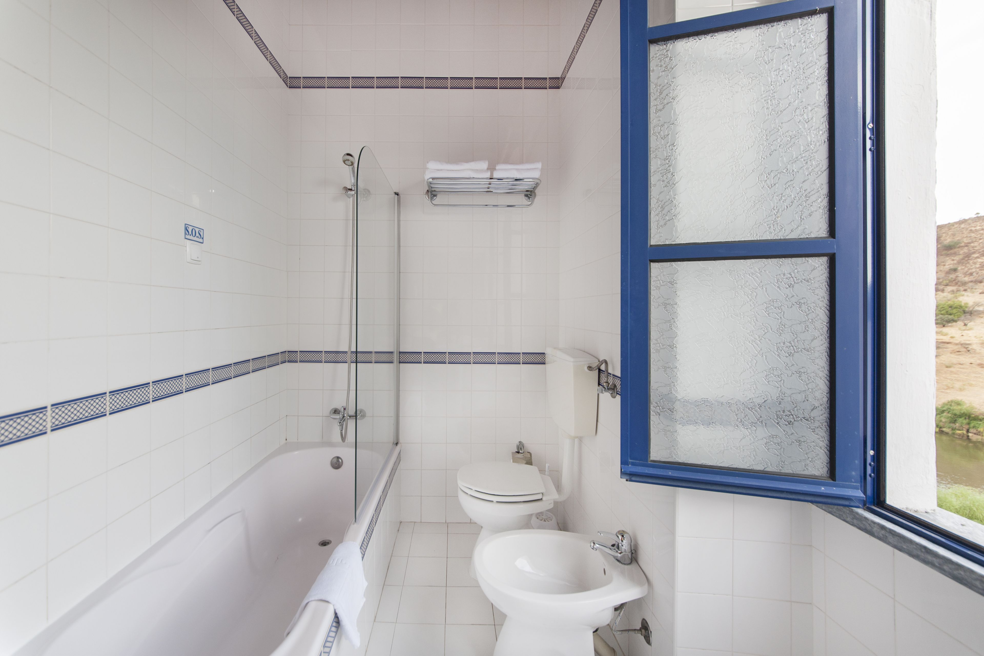 A bathroom with a bathtub, toilet, and shower.
