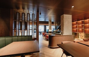 A modern interior with seating, a counter, and a staircase. - Hotel Belisario - Provenza (Medellín)