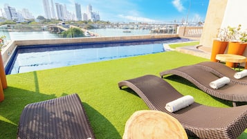 Outdoor pool, open 9 AM to 7 PM, pool loungers