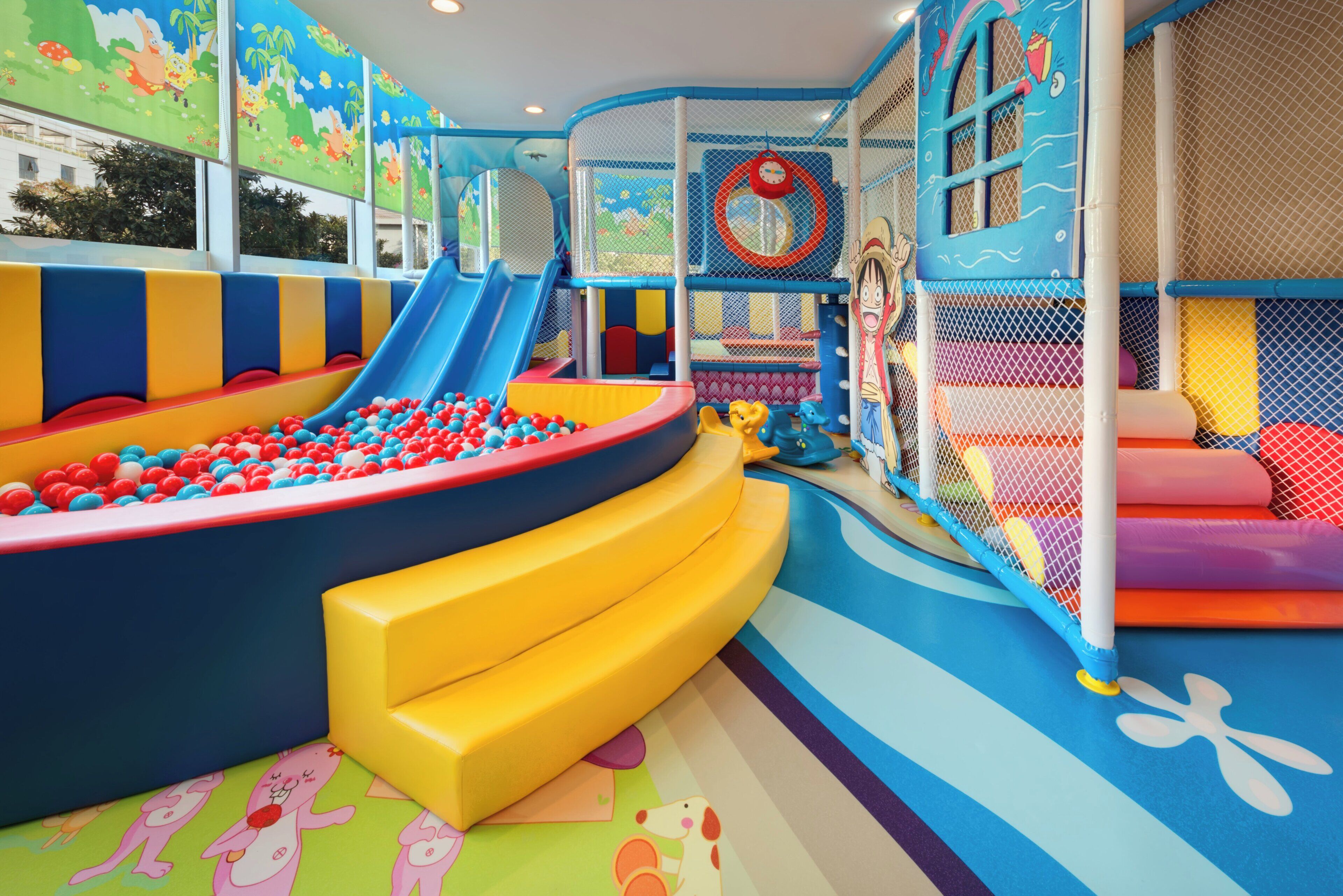 A children's play area with slides, ball pits, and soft play structures.