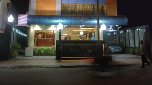 A multi-story hotel with a modern design, featuring large windows and a prominent entrance. - Hotel Pan Asia Continental (Kolkata)