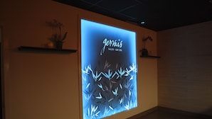 A wall with a digital display advertising 'gervaix SALON - DAY SPA'. - Inn at the 5th (Eugene)