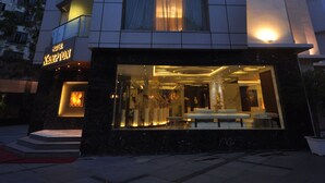 A hotel with a modern facade, multiple floors, and illuminated signage. - Hotel Kempton (Kolkata)
