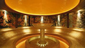 Experience the tranquil ambiance of this serene space, surrounded by a stunning mosaic-tiled fountain and a vibrant mural of autumn foliage.
