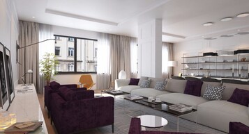 A modern living room with a sofa, armchairs, and a coffee table. There is a large window with curtains, a plant, and a bookshelf.