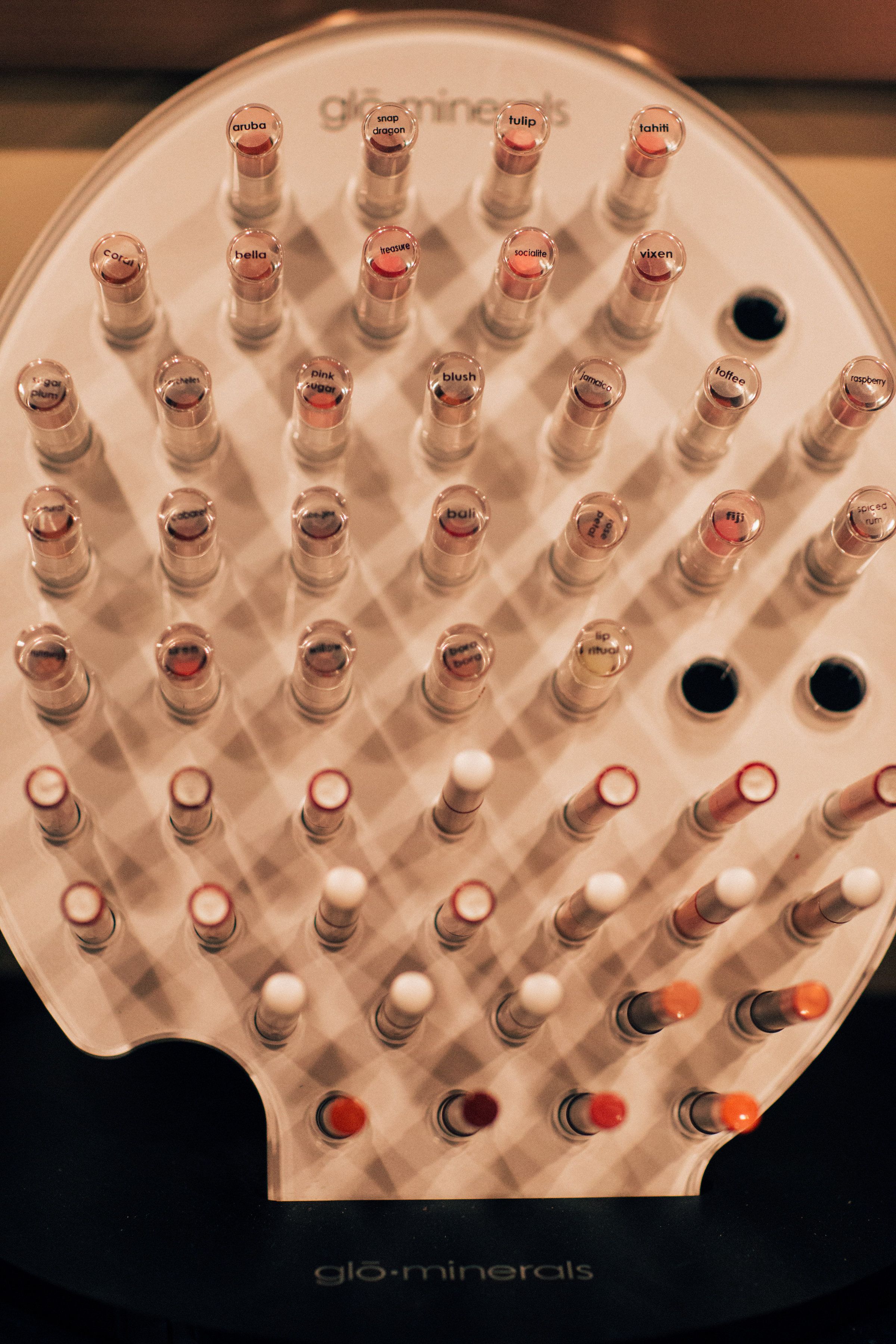 A display of lipsticks arranged in rows on a stand.
