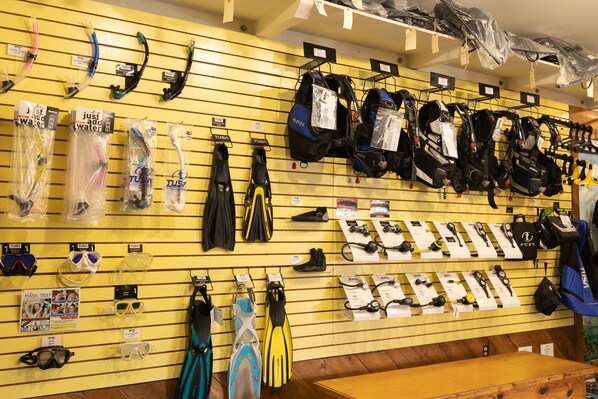 A store with various diving equipment like masks, fins, and wetsuits displayed on shelves. - Looe Key Reef Resort (Summerland Key)