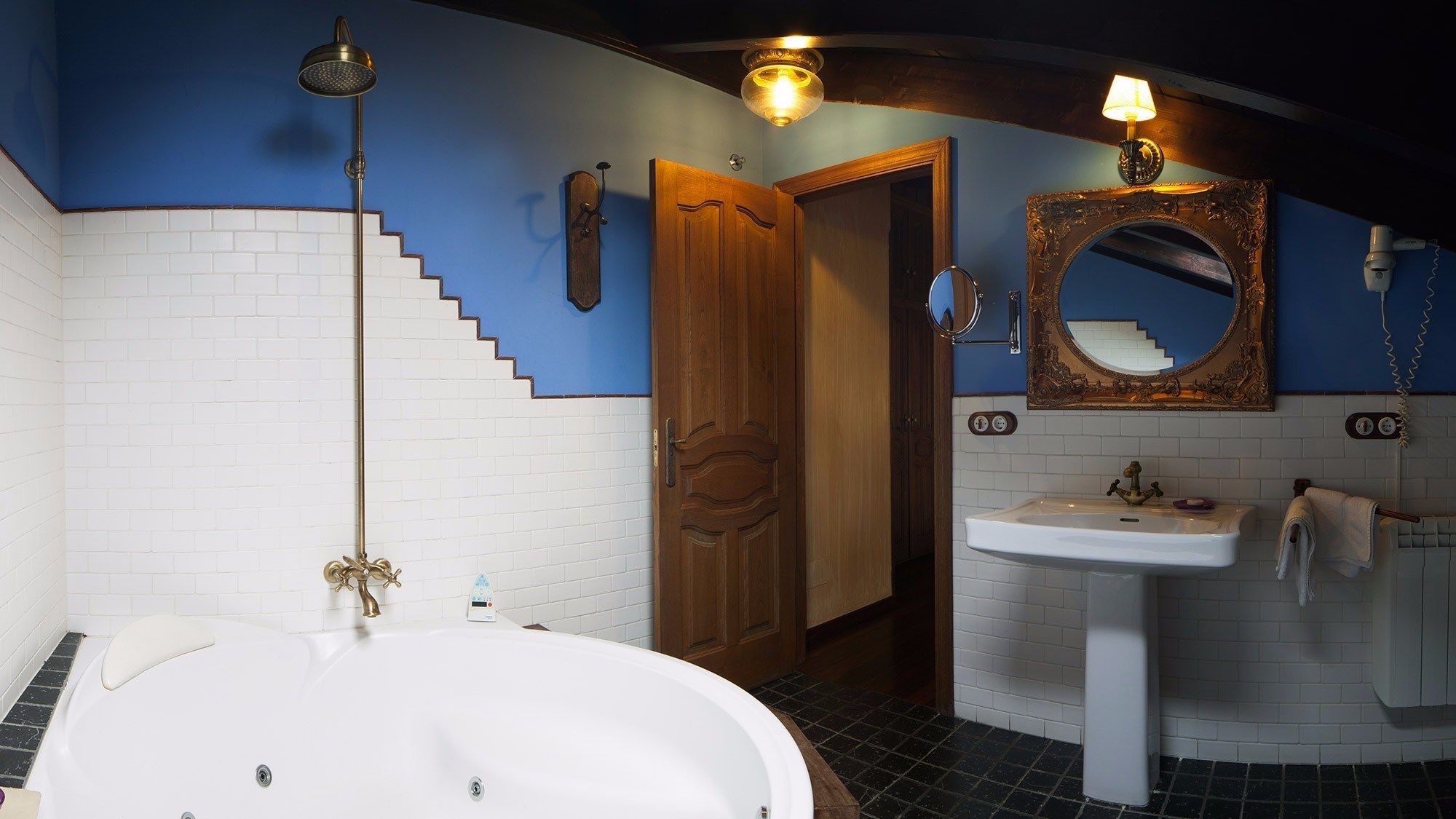 A bathroom with a white bathtub, a sink, a mirror, and a shower.
