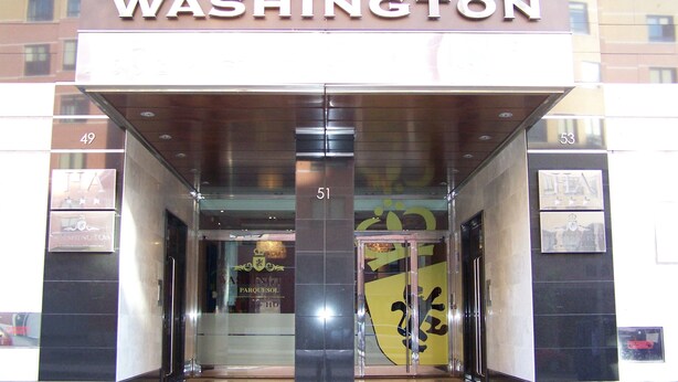 The entrance to a building with the sign "WASHINGTON" above the doors.
