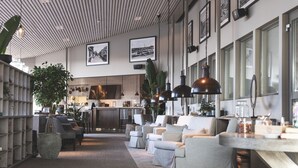 A modern interior with a kitchen area, seating, and a bar. - Torekov Hotell (Torekov)