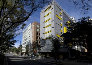 A multi-story building with a modern architectural design, featuring a mix of glass and concrete facades. - BOG Hotel  (Bogotá)