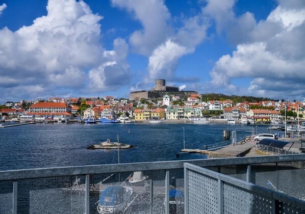 A harbor with a historic castle, colorful buildings, and boats. - Marstrands Havshotell (Marstrand)