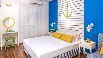 A bedroom with a bed, bedside tables, a mirror, and a wall-mounted air conditioner.
