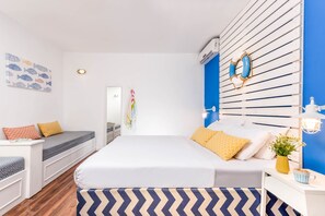 A modern bedroom with a bed, built-in seating, a bedside table, and a wall-mounted air conditioning unit.
