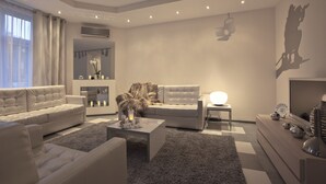 A modern living room with a sofa, coffee table, and a TV stand. - Dom Aktera (Odesa)