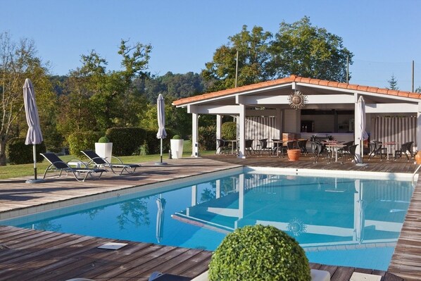 Outdoor pool, open 10:00 AM to 8:00 PM, pool umbrellas, pool loungers