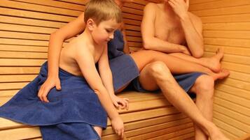 Relax and unwind in this serene sauna room, featuring comfortable benches and a tranquil atmosphere.