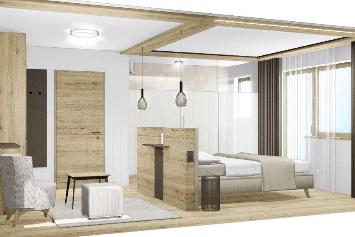 Une chambre à coucher moderne avec un lit, une table de chevet, une chaise et une petite table.