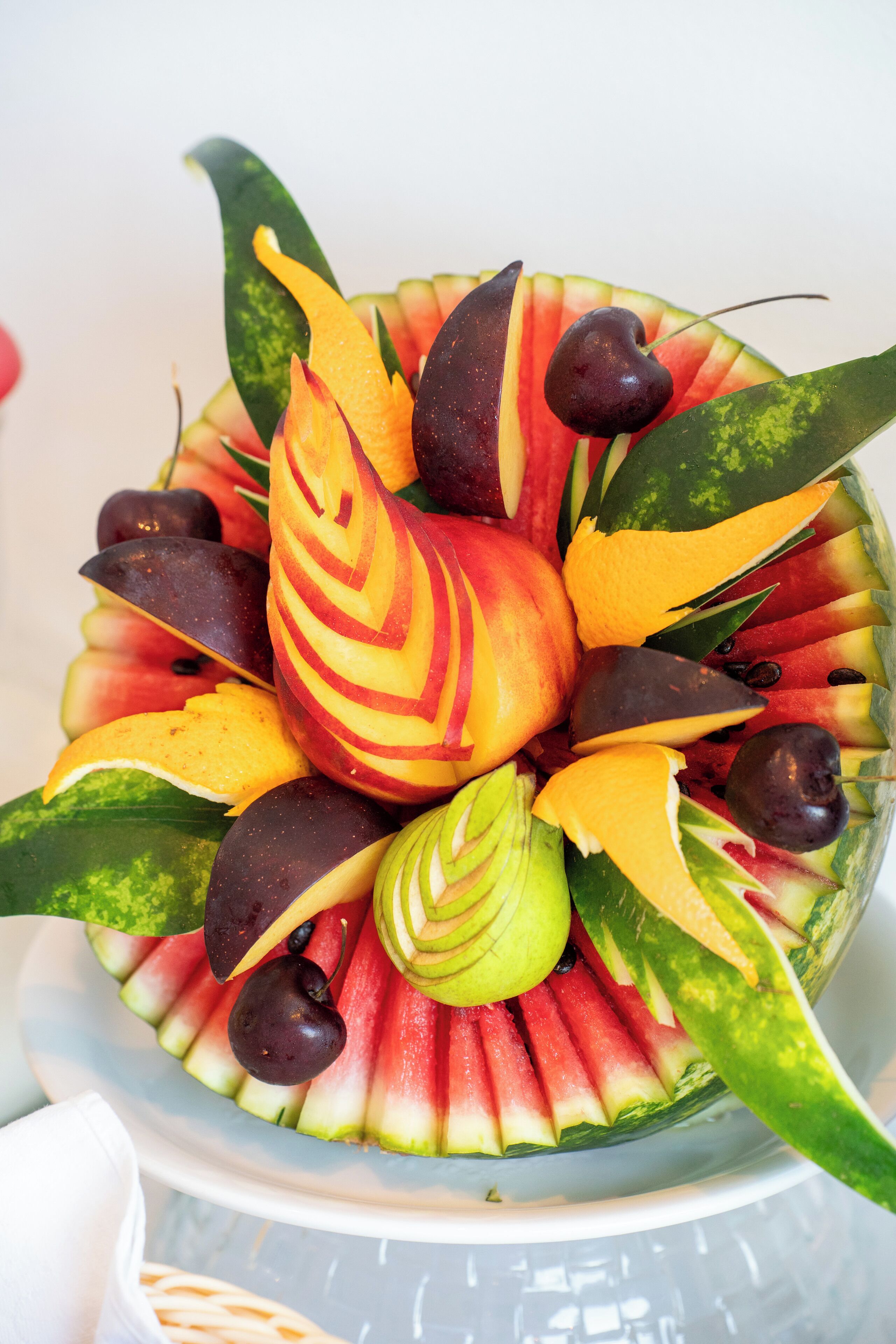 A bowl of fruit arranged in a decorative pattern.