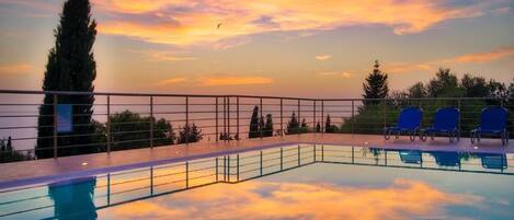 Seasonal outdoor pool, open 9:00 AM to 8:30 PM, pool umbrellas