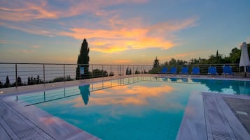 Seasonal outdoor pool, open 9:00 AM to 8:30 PM, pool umbrellas