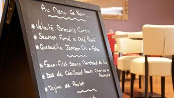 A chalkboard menu listing various dishes.